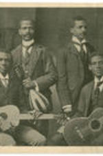 George A. Towns and three other  men pose for a picture while holding instruments.