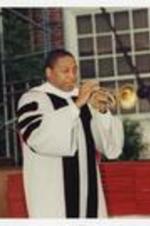 Wynton Marsalis plays his trumpet on stage at commencement.