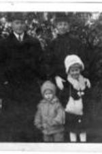 Two children with their parents. Written on verso: New Year greetings from the Lathrofs.