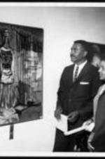 Mrs. Gerald Hooper and others look at an artwork titled "Martyr".