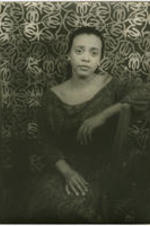 Portrait of Adele Addison leaning on the back of a chair. Written on verso: Photograph by Carl Van Vechten; 146 Central Park West; Cannot be reproduced without permission; April 8, 1955.