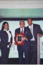 Representatives from Remy Martin pose with Joseph E. Lowery, who holds an award plaque presented to him.