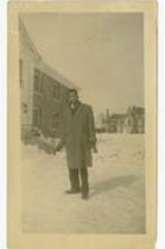 Gladstone "Mickey" Chandler, Jr. standing in the snow on campus. Written on verso: Me in front of Battell North. Paulina caught me off guard.