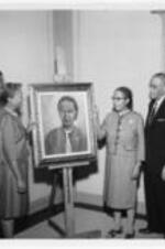 Frankie V. Adams and others pose with a painting of Mrs. Simon. Written on verso: The portrait of Miss Frankie Adams by Jewel Woodard Simon which was presented to the Atlanta University School of Social Work by the National Alumni Association of the School of Social Work (l. to r.) Clarence Coleman, Class �47, Mrs. Simon, Class �31, Miss Frankie Adams, Dr. Rufus E. Clement, and Dr. William S. Jackson, dean, Atlanta University School of Social Work.