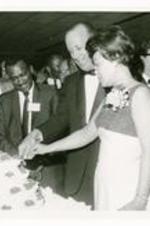 Hugh M. Gloster and his wife cutting layered cake "101 Morehouse College."
