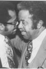 Ralph D. Abernathy is shown speaking with an unidentified man. Written on verso: Look Alikes; Dr. Abernathy and friend at Young Brown reception