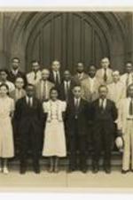 A group portrait of James P. Brawley and Deans of Frisk University in front of a building.