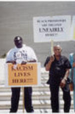 Joseph and Evelyn Lowery stand with two other demonstrators holding protest signs outside of the Creative Artists Agency in Beverly Hills, California.