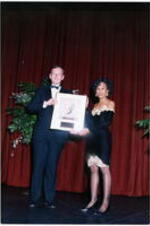 An unidentified man and woman holding an award at the Atlanta Student Movement 20th anniversary event.