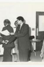 Written on verso: "Dr. Colvert H. Smith awards Phil Mitchell on Honors Day: Dr. Luther Williams Pres of Altanta University looks on. Dr. Williams was the Honors Day speaker.".