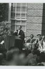 Written on verso: Clark College Commencement Exercises ca. May 1975, Left to right: 1. Rev. Henderson, 2. Andrew Young, 3. Dr. Averett A. Burruss, 4. Dr. Vivian Henderson, 5. Dean Curtis Gillespie, 6. Dr. Edward Simon, 7. Dr. Clarence Coleman, 8. Dr. Charles Knight.