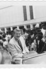 WSB Newscaster Dave Sisson rides in a parade car. Written on accompanying document: Dick Sisson (Newsman).