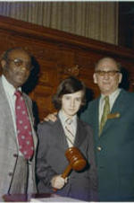 Tom Murphy stands with an unidentified man and a young man holding a gavel at the Georgia House of Representatives.