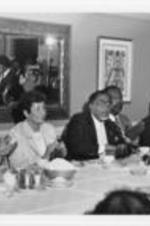Joseph and Evelyn Lowery are shown sitting with other Southern Christian Leadership Conference Board members at a luncheon meeting. Written on verso: Dr. Joseph Lowery meets the press and others gathered.