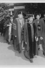 Dr. Harry Richardson walks in procession with other professors during commencement.