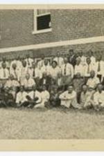 Outdoor group portrait of men and women. Written on verso: St. Louis Area School of Ministerial Training.