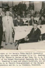 A group of people in a dining room. Written on recto: The Georgia State Baptist Convention in Columbus, Georgia which convened November 13 to 15.  Reading left to right are Dr. Thomas S. Harten of New York, Dr. J. M. Gadson of Philadelphia. Standing in back are Albert Rathblott, son of Mr. Rathblott, Dr. L. M. Terrill Vice-President of the Georgia State Baptist Convention and Dr. L. A. Pinkston, President.
