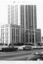 View of the exterior of the Atlanta City Hall with cars parked out front.