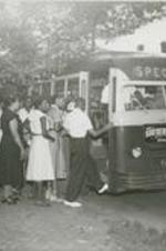 A view of people board a bus.
