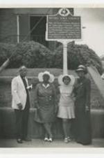 George A. Sewell and women stand in front of the historic site sign of Bethel AME Church.