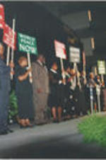 Reverend Fred Taylor, Frederick Moore, Lula Williams, Reverend James Orange, and others are shown holding demonstration signs at Joseph E. Lowery's 80th birthday celebration.
