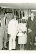 Written on verso: Brunch at home of the President Gloster on Commencement Day, May 19, 1985: L. to R.: Mayor Coleman Young, President Gloster, Mr. Lawrence Small, Dr. Thomas Kilgore Jr, Mrs. Kilgore, Mr. Walter Wriston, and Mr. Sidney Poitier.