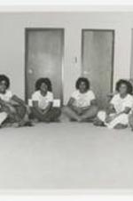 Indoor group portrait of 6 young women.