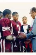 President Hugh Gloster with unidentified Morehouse College football players.