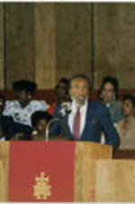 Dick Gregory is shown speaking at a Southern Christian Leadership Conference Spring Board meeting held at Grace Temple Baptist Church in Detroit, Michigan.