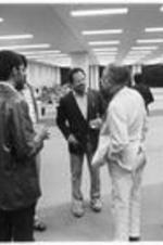 Men talk at a reception at the Conference to Access the State of Black Arts and Letters in Chicago, IL. May 26-28, 1972.