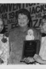 Rosa Parks and Evelyn G. Lowery are shown presenting Septima Clark with the SCLC/W.O.M.E.N. Award for "Dedicated Service to the Movement for Justice &amp; Peace" at the 29th Annual Southern Christian Leadership Conference Convention.