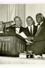 Written on verso: Honorable Percy Sutton, Borough President of Manhattan, shown presenting the Proclamation Declaring November 10 Morehouse College Day in New York. (L. to R.) Malcolm L. Corrin, '50; Dr. Hugh M. Gloster, '31; Borough President Sutton; Dr. Benjamin E. Mays. November 10, 1967.