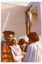 Coretta Scott King with unidentified persons in front of Dr. MLK statue.