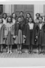 Junior Neighborhood Union Group standing on steps holding an award circa 1920.