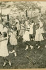 Students perform a synchronized dance outside.