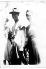 Three unidentified people stand in a group.