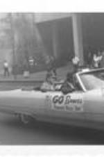 Braves Manager Lum Harris rides in the back of a car in the Braves Pennant Rally parade. Written on accompanying document: Go get em Braves Parade Mgr. Luman Harris.