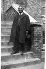 Reverend Barnwell stands on the steps of a building. Written on verso: Feb. 23, 1923. Rev. Barnwell, former superintendent of the southeastern district, for whom Barnwell Community is named.