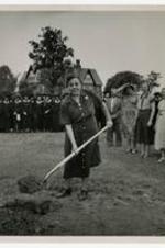 View of Miss Johnnie Louise Fowler with shovel at the groundbreaking ceremony for the new gymnasium and Health and Recreation Building in 1950.