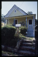 A view of a shotgun house. Text from slide presentation: scholars note that the form is similar to house types that can be traced from Africa, through the West Indies to New Orleans, and from there throughout the south.