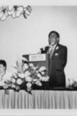 Joseph E. Lowery is shown speaking at the 1st National Conference on AIDS and the Black Community. For more details on the conference, see pages 42-45 of the August-September 1986 SCLC Magazine: http://hdl.handle.net/20.500.12322/auc.199:07030. Written on verso: Dr. William Osborne, Evelyn G. Lowery, Dr. Joseph Lowery, Dr. Huey Mays.