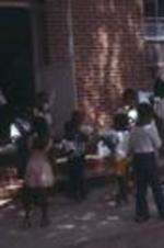 A group of children eating ice cream stand outside the Monroe Street Church of God in Christ. Bishop Dell pastored there for over 30 years in Albany, Georgia.