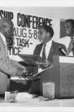 Southern Christian Leadership Conference (SCLC) President Joseph E. Lowery is shown presenting an award at the 28th Annual SCLC Convention.