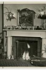 Interior view of fireplace in Reynolds Cottage at Christmas.