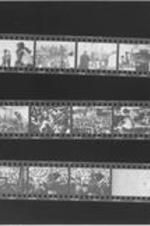 A contact sheet containing three strips of 35mm negative images that depict a crowd gathered in the parking lot of the Lorraine Motel and a number of flowers and plants marking the room from which Martin Luther King, Jr. exited and was assassinated.