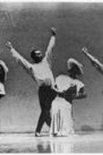 Alvin Ailey dancers perform on stage. Alvin Ailey is on the far left.