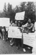 A group of protesters are seen holding protest signs in Chester, South Carolina.