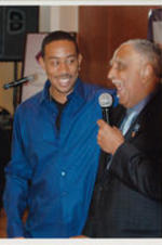 Ludacris and Joseph E. Lowery are shown sharing a hug at an event.