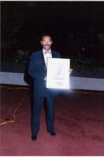An unidentified man holds an award at the Atlanta Student Movement 20th anniversary event.