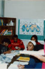 A woman is shown teaching a group of young adults at the SCLC/W.O.M.E.N. Learning Center.